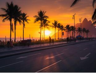 sunset-over-ipanema-beach-with-palms-in-rio-de-janeiro-brazil-picture-id923515838