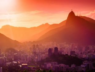 sunrise-on-a-city-nestled-at-the-bottom-of-hillside-picture-id179675797